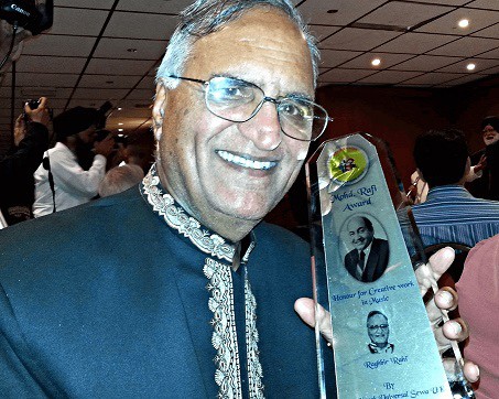 Mr Rahi Bains holding the prestigious "Mohd. Rafi Award" given to him as an honour for his "Creative Work in Music" in London in June 2014.